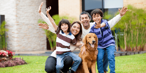 Happy Family Smiling With Their Dog Image