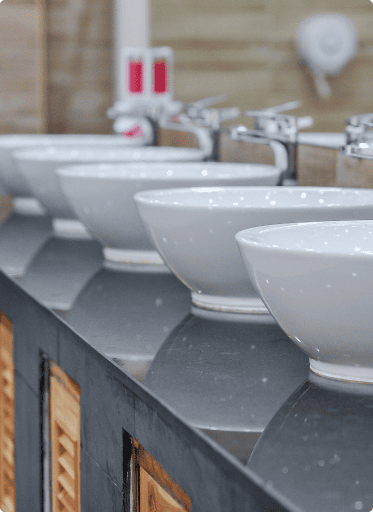 White bowl sinks dark countertop silver faucets cabinet